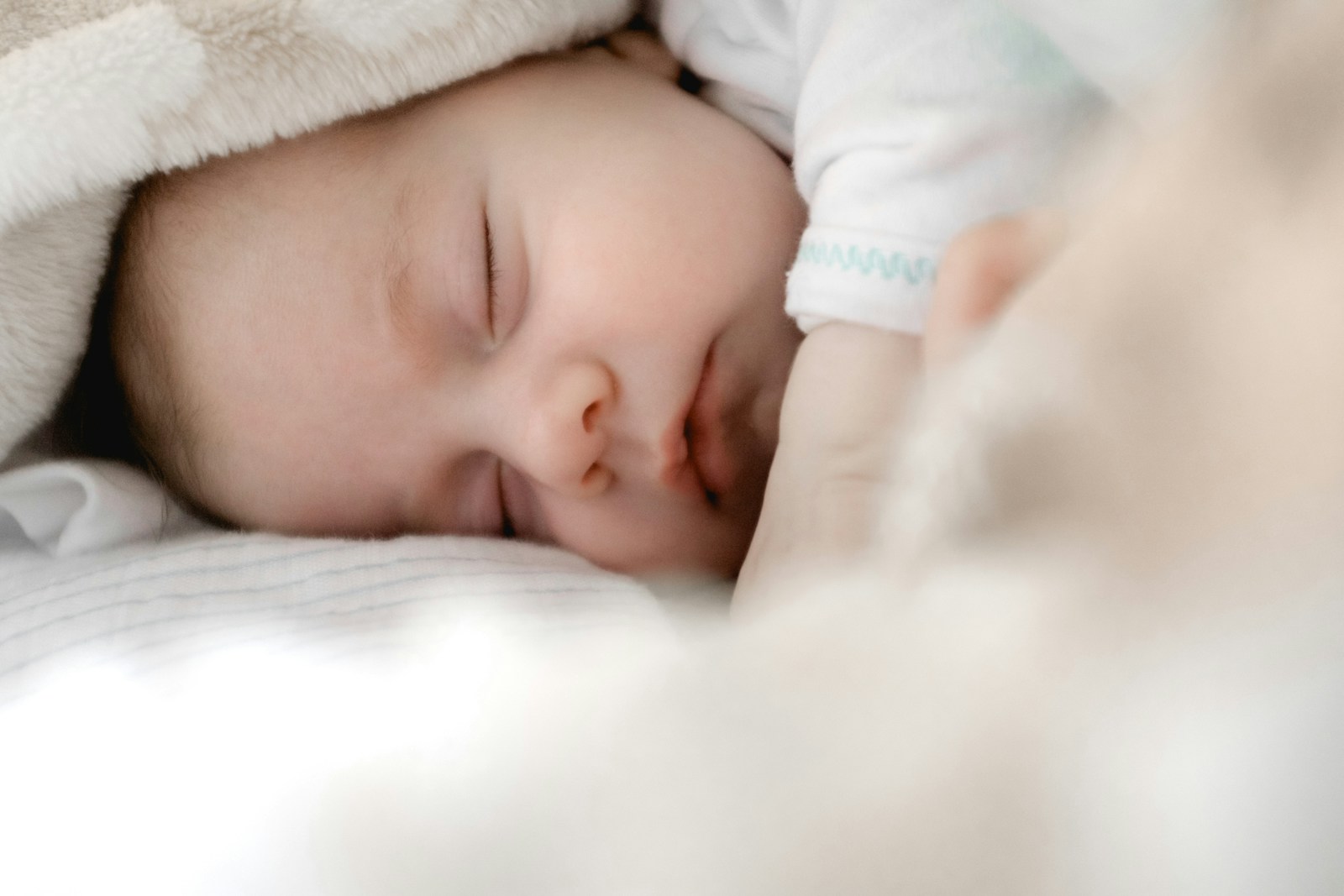 A newborn baby sleeping peacefully at home
